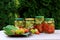 Preserves vegetables in glass jars on the table in summer garden. glass jars with various vegetables