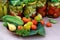 Preserves vegetables in glass jars on the table in summer garden. glass jars with various vegetables