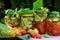 Preserves vegetables in glass jars on the table in summer garden. glass jars with various vegetables