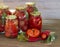 Preserves vegetables in glass on wood background, marinated fermented and pickled fermer food