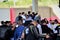 President Bolsonaro leaves the CCA event park, waving and surrounded by security guards in the car body