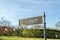 President J.F. Kennedy Gravesite Sign. Sunny Day with Blue Sky at Arlington National Cemetery in Washington DC, USA