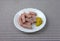 Pressed pork canned meat chunks on a plate with mustard.