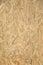 Pressed wooden OSB panel background. Vertical texture of oriented strand board