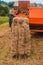 Pressing hay into bales, old working press, harvesting and harvesting dry fodder