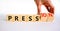 Pression to free press symbol. Businessman turns wooden cubes and changes the word pression to press. Beautiful white table, white