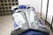 Pressure therapy gray massaging suit on blue couch in spa, treatment of varicose veins