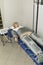 Pressure therapy procedure. Woman lying in massaging suit in spa clinic, treatment of