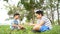 Preteen Asian boy sit and play on a grass