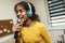 Preteen black girl holding microphon singing karaoke at home, recording songs for contest. Children\'s lifestyle concept