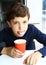 Preteen boy with cappuccino coffee in paper glass