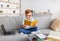 Preteen boy doing homework at home, using laptop