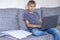 Preteen boy doing homework mathematics tasks with laptop computer at home. Technology, online learning, distance