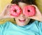 Preteen boy with doughnut glasses close up
