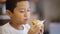 Preteen boy eating a tasty hamburger