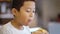 Preteen boy enjoying a tasty cheeseburger