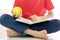 Preteen boy enthusiastically reading interesting book and eating an apple. Kid reader enjoying interesting stories, reading