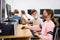 Preteen boy and girl in protective mask learn to solve problems on computer in school classroom