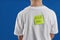 Preteen boy with KICK ME sticker on back against background, closeup. April fool`s day