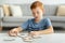 Preteen boy playing with wooden puzzles at home