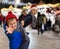 Preteen boy pulling mom hand at outdoor Christmas market