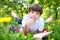 Preteen boy reading book outdoor spring