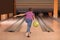 Preteen boy throwing ball at bowling