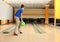 Preteen boy throwing ball at bowling. Space for text