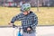 Preteen boy walking bicycle looking at handlebars, getting ready