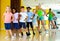 Preteen boys and girls practicing dance, stretching with female