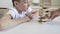 A preteen caucasian boy playing wooden block tower board game with his mom for practicing physical and mental skill and