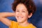 Preteen curly boy laughing and looking at camera