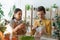 Preteen friends holding plant and magnifying