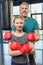 Preteen girl boxing with senior trainer