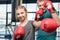 Preteen girl boxing with senior trainer