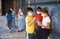 Preteen girl and boy schoolmates in protective masks talking outdoor