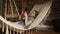 Preteen girl child lying in hammock