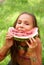 Preteen girl eats watermellon