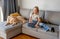 Preteen girl with golden retriever at home