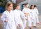 Preteen girl mastering karate moves during group class outdoors