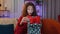 Preteen girl opening gift box with light glow inside amazed satisfied with present birthday surprise