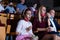 Preteen girl in protective mask watching movie in cinema