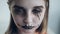 Preteen girl with spooky Halloween makeup