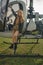 Preteen girl standing on footboard of open helicopter