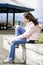 Preteen girl tying shoes outdoors