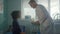 Preteen girl visit doctor in hospital office. Pediatrician talking with patient.