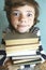 Preteen handsome boy with book pile