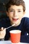 Preteen handsome boy with cappuccino paper glass