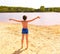 Preteen handsome boy on the shore of the country lake