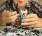 preteen hansome boy show the result of his rainbow loom hobby